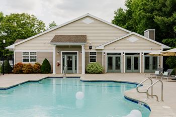 A house with a pool in front.